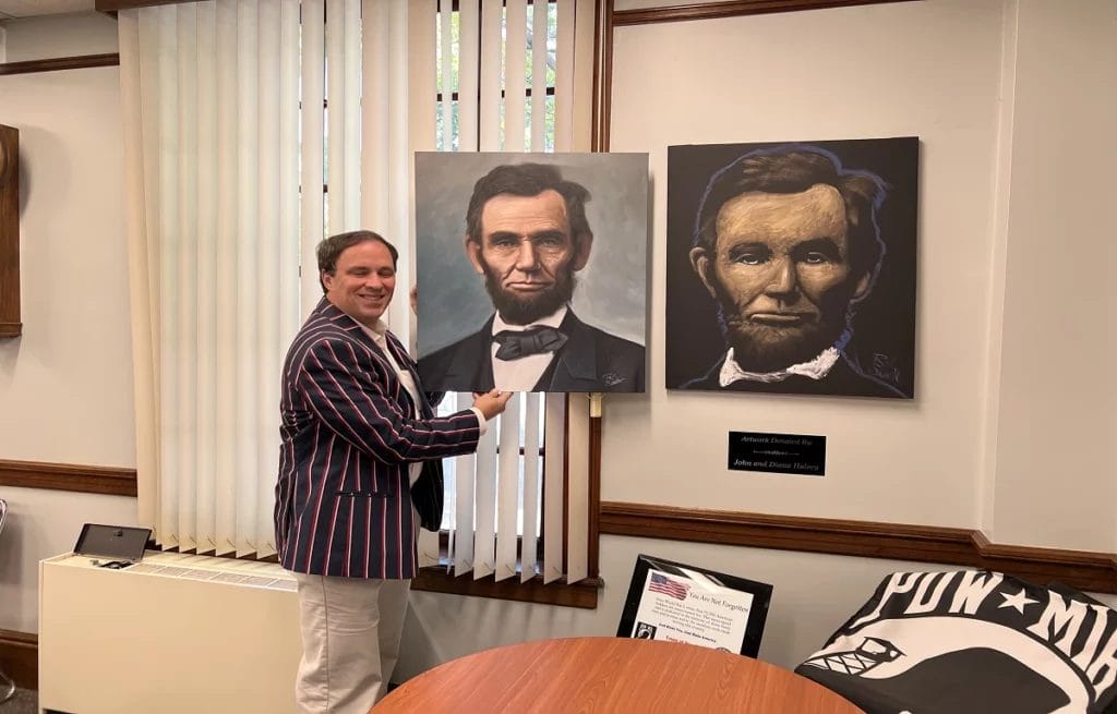 Rob Surette with his before and after Abraham Lincoln painting.