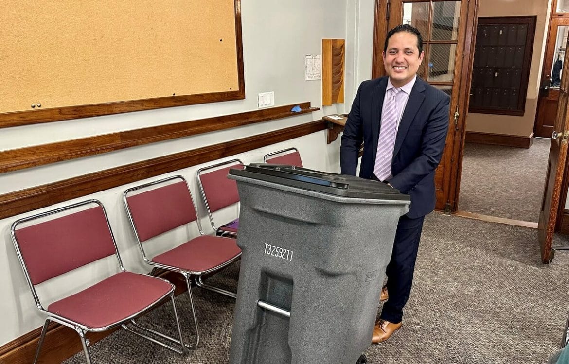 Town Manager Fidel Maltez demoing the 64 gallon trash barrel option at the Select Board earlier this year.